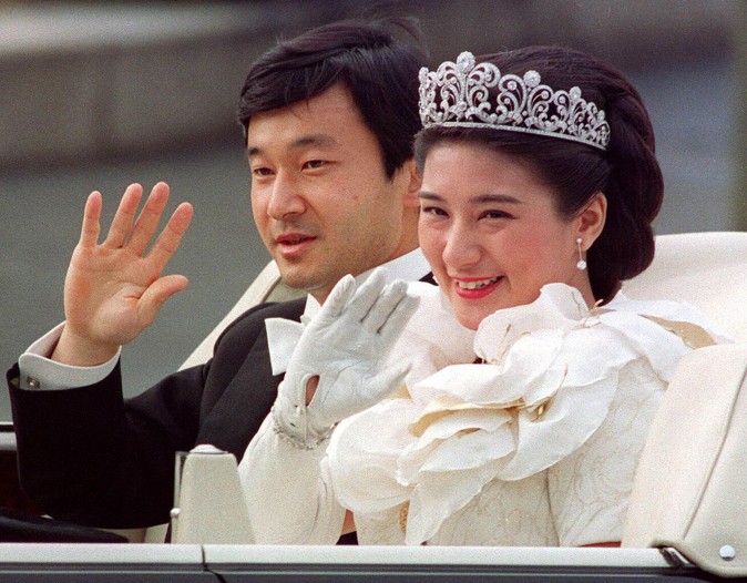 This file photo dated 9 June, 1993, shows Japanese Crown Prince Naruhito (L) and Crown Princess Masako (R) waving to people during the parade after their wedding ceremony in Tokyo. (AFP/AFP/Getty Images)