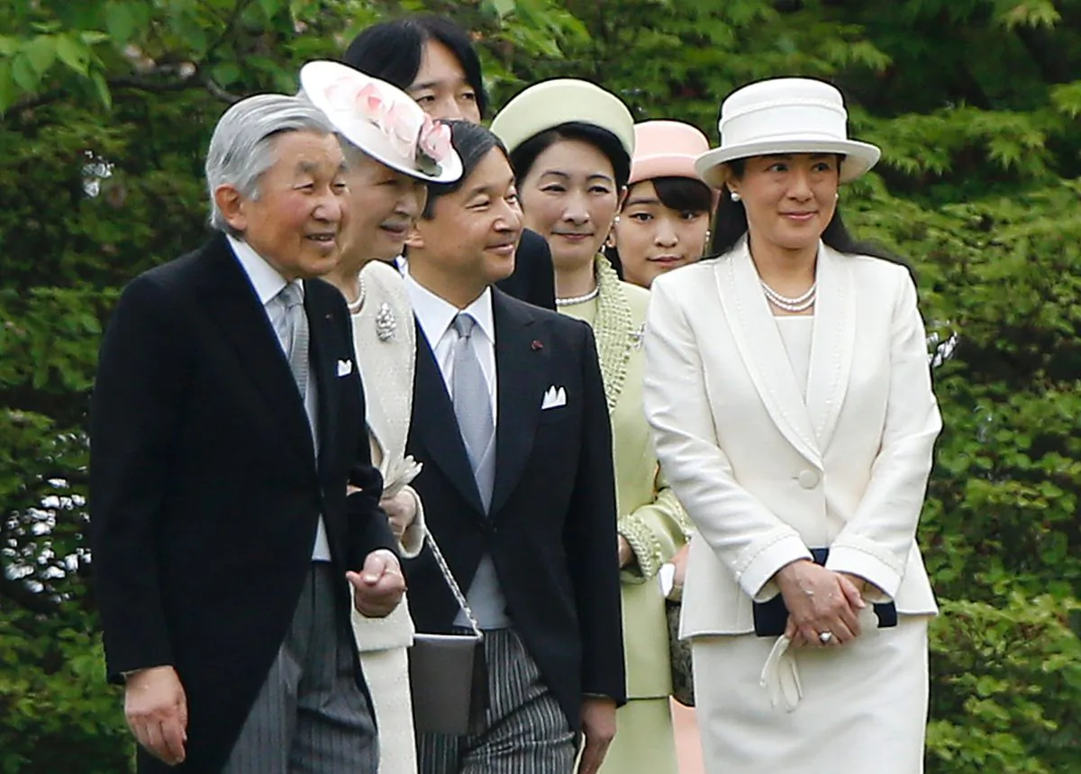 Japanese Emperor Akihito (L), Empress Michiko (2nd L), Crown Prince Naruhito (3rd L, and his wife, Princess Masako (R), Prince Akishino (4th L) and his wife, Princess Kiko (3rd R), and Princess Mako (2nd R) walk down a hill to greet guests during the spring garden party at the Akasaka Palace imperial garden in Tokyo on April 27, 2016. (Shizuo Kambayashi/AFP/Getty Images)