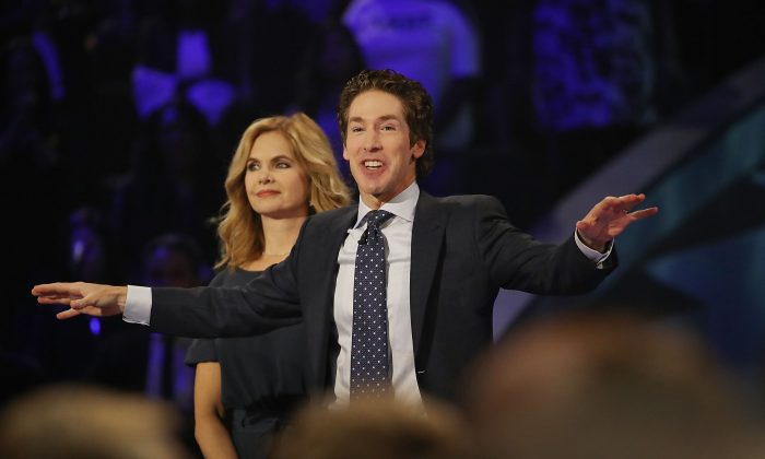 Joel Osteen, the pastor of Lakewood Church, stands with his wife, Victoria Osteen, as he conducts a service at his church as the city starts the process of rebuilding after severe flooding during Hurricane and Tropical Storm Harvey in Houston, Texas on Sept. 3, 2017. (Joe Raedle/Getty Images)