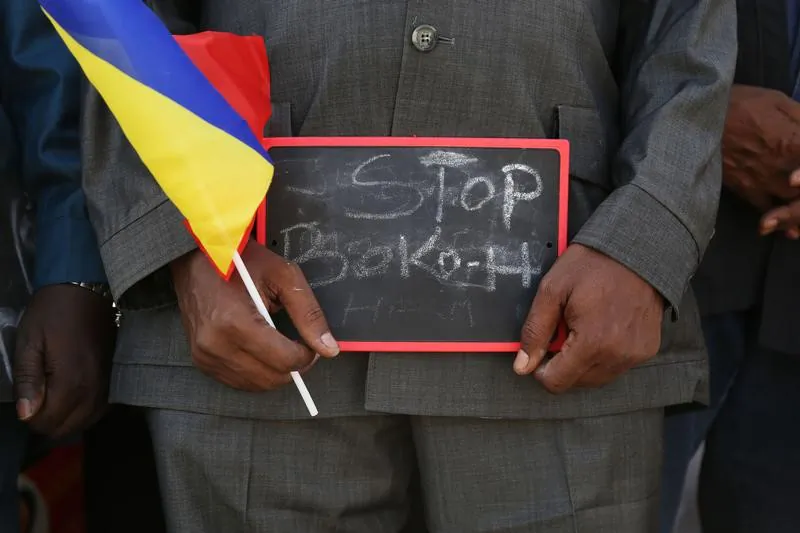 A man holds a sign that reads "Stop Boko Haram" at a rally to support Chadian troops heading to Cameroon to fight Boko Haram, in Ndjamena Jan. 17, 2015. (Emmanuel Braun/Reuters)