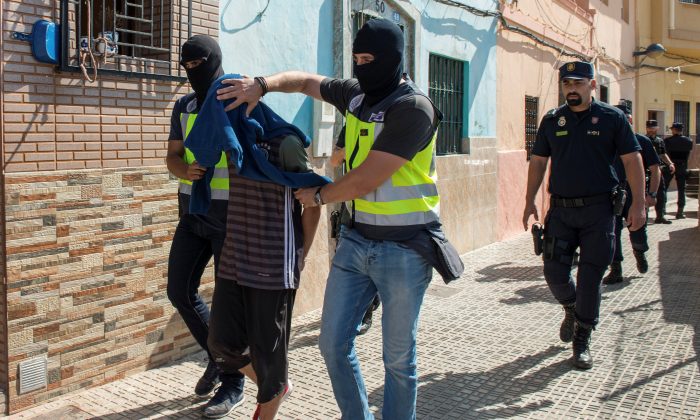 Spanish police arrest a man suspected of belonging to an Islamist militant cell that simulated decapitations in the Spanish north African enclave of Melilla on Sept. 6, 2017.  (REUTERS/Jesus Blasco de Avellaneda)
