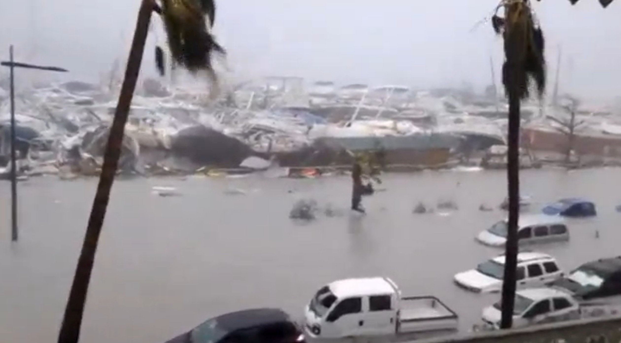 General view of half-submerged vehicles, boats and debris in the flooded harbour as Hurricane Irma hits the French island territory of Saint Martin September 6, 2017. (RCI GUADELOUPE/Handout via REUTERS)