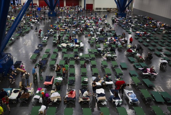 Evacuees fill up cots at the George Brown Convention Center that has been turned into a shelter run by the American Red Cross to house victims of the high water from Hurricane Harvey on August 28, 2017 in Houston, Texas. (Erich Schlegel/Getty Images)