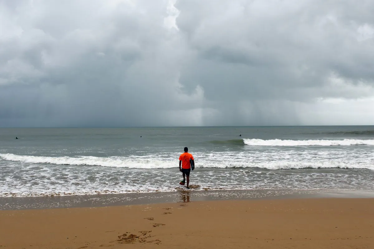 A surfer walks into the ocean in the waters of La Pared Beach in the aftermath of Hurricane Irma in Luquillo, Puerto Rico, on September 7, 2017. Puerto Rico was spare the brunt of Irma, though still suffered extensive damage. (RICARDO ARDUENGO/AFP/Getty Images)