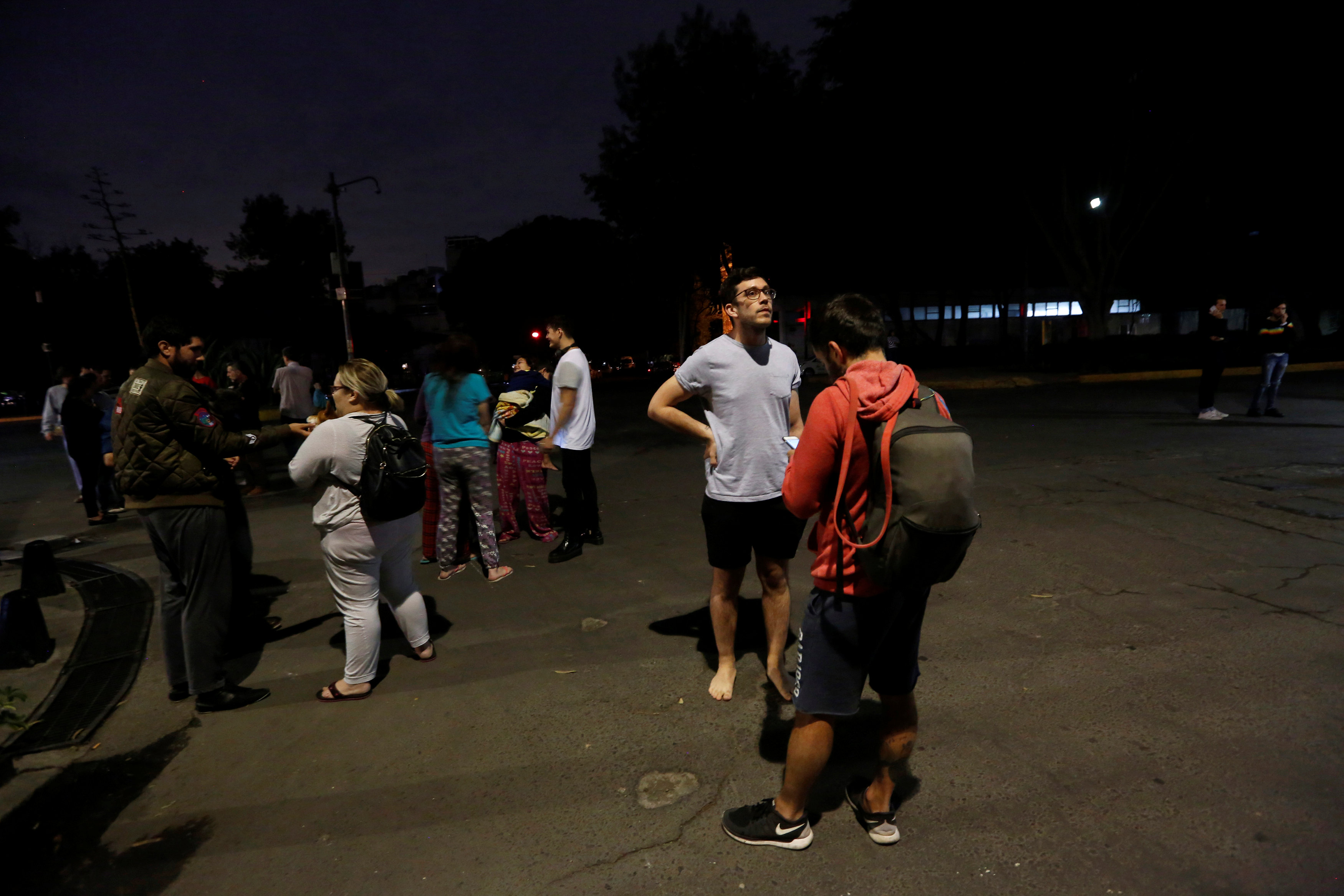 People gather on a street after an earthquake hit Mexico City, Mexico late Sept. 7, 2017. (REUTERS/Claudia Daut)