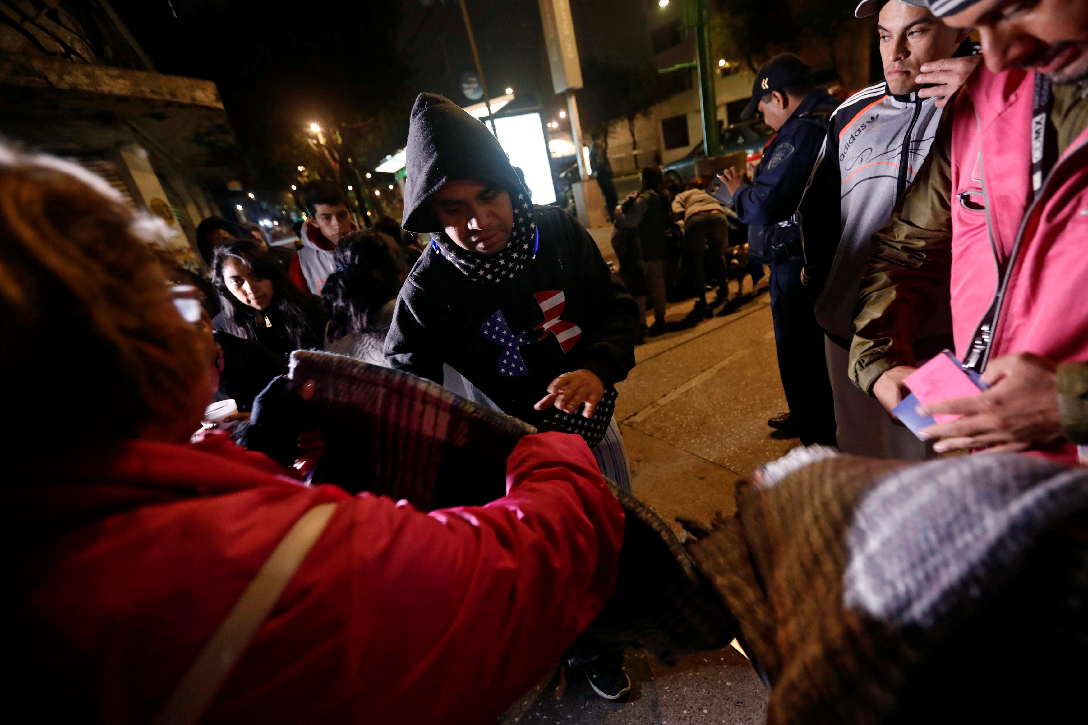 People gather on a street as they receive blankets after an earthquake hit Mexico City, Mexico on Sept. 8, 2017. (REUTERS/Edgard Garrido)