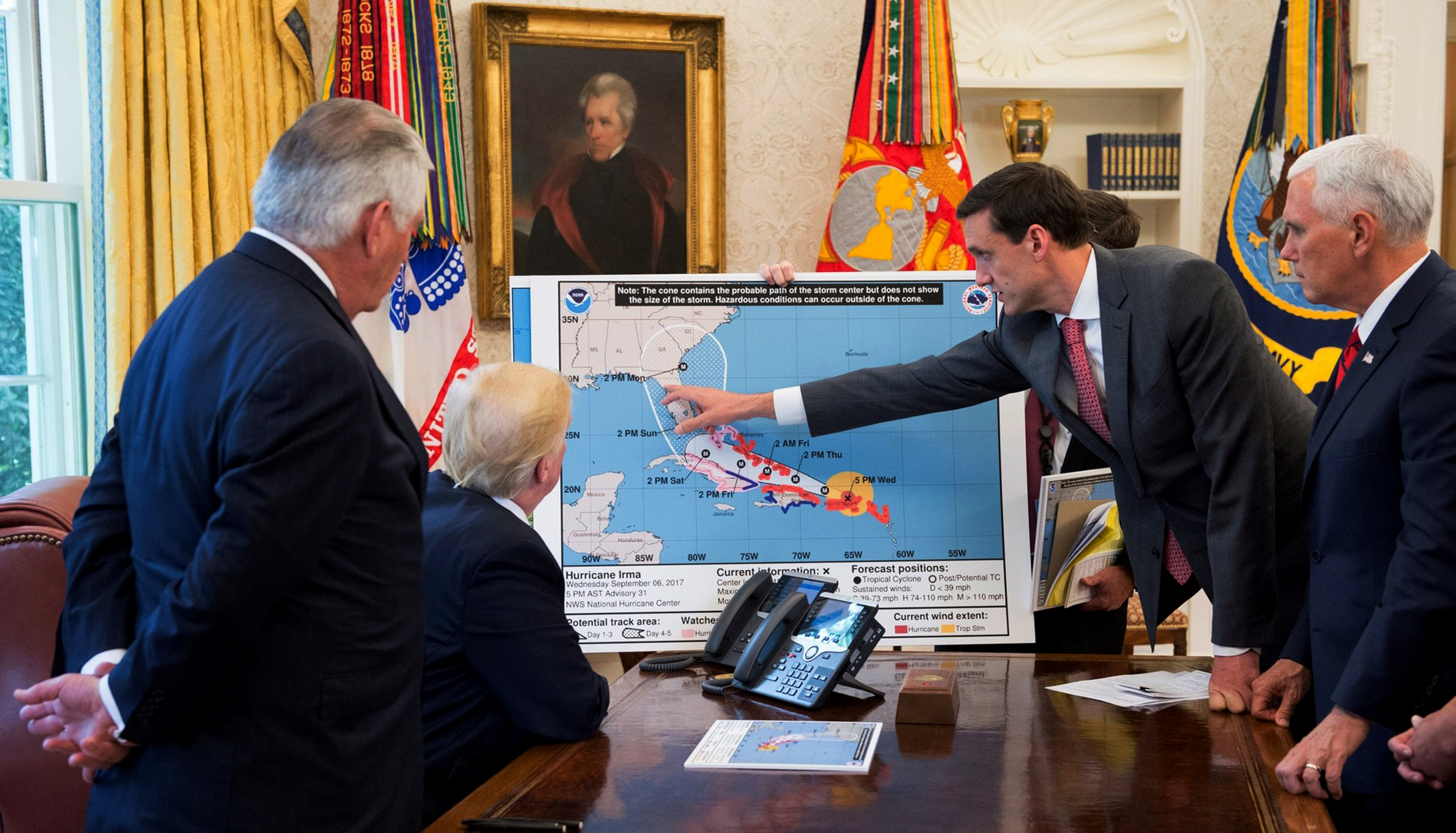 U.S. President Donald Trump is seen in an official White House handout photo with U.S. Secretary of State Rex Tillerson (L), Homeland Security and Counterterrorism Adviser Thomas Bossert (2ndR) and Vice President Mike Pence (R) as he participates in an Oval Office briefing tracking the approach of Hurricane Irma toward the coast of Florida, at the White House in Washington on Sept. 7, 2017. (Andrea Hanks/Courtesy of the White House/Handout via REUTERS)