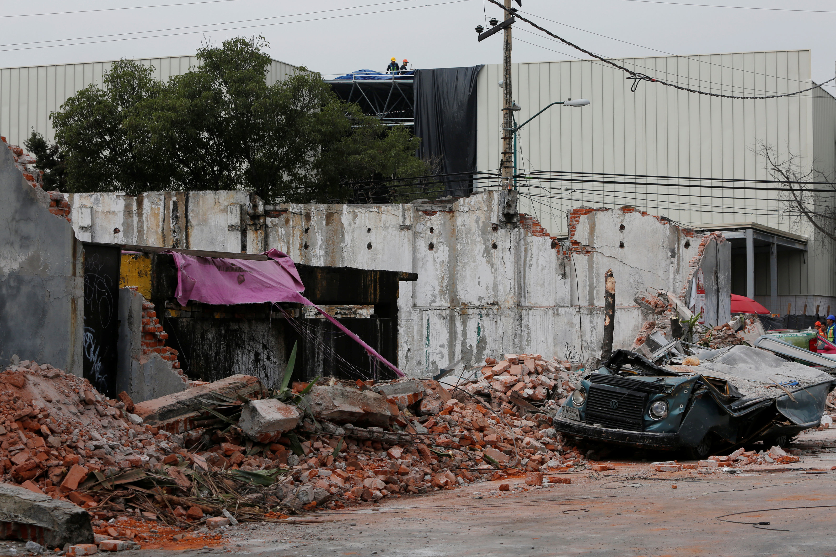 A damaged wall and a smashed vehicle are pictured after an earthquake in Mexico City, Mexico on Sept. 8, 2017. (REUTERS/Carlos Jasso)
