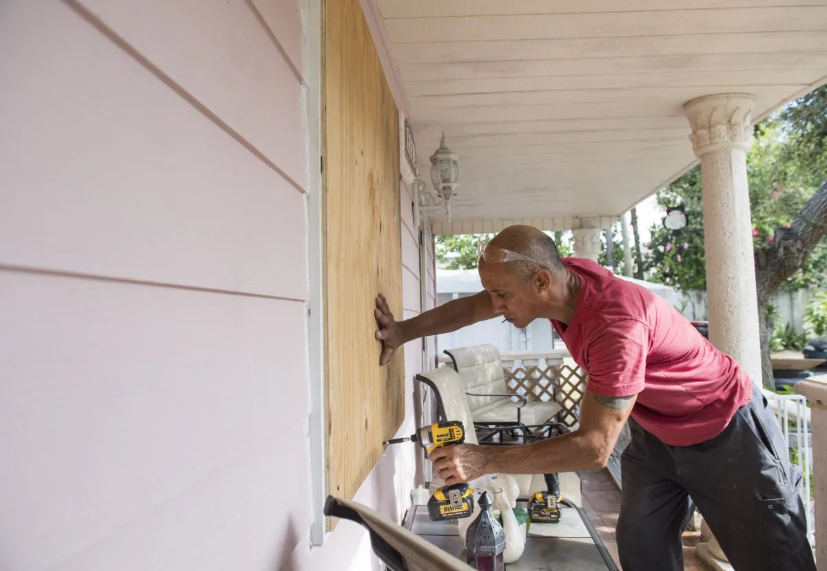 Pedro Marti covers the windows of his home with wood at the Sunnyside Trailer Park during preparations for Hurricane Irma in West Miami, Florida, September 8, 2017.  (SAUL LOEB/AFP/Getty Images)