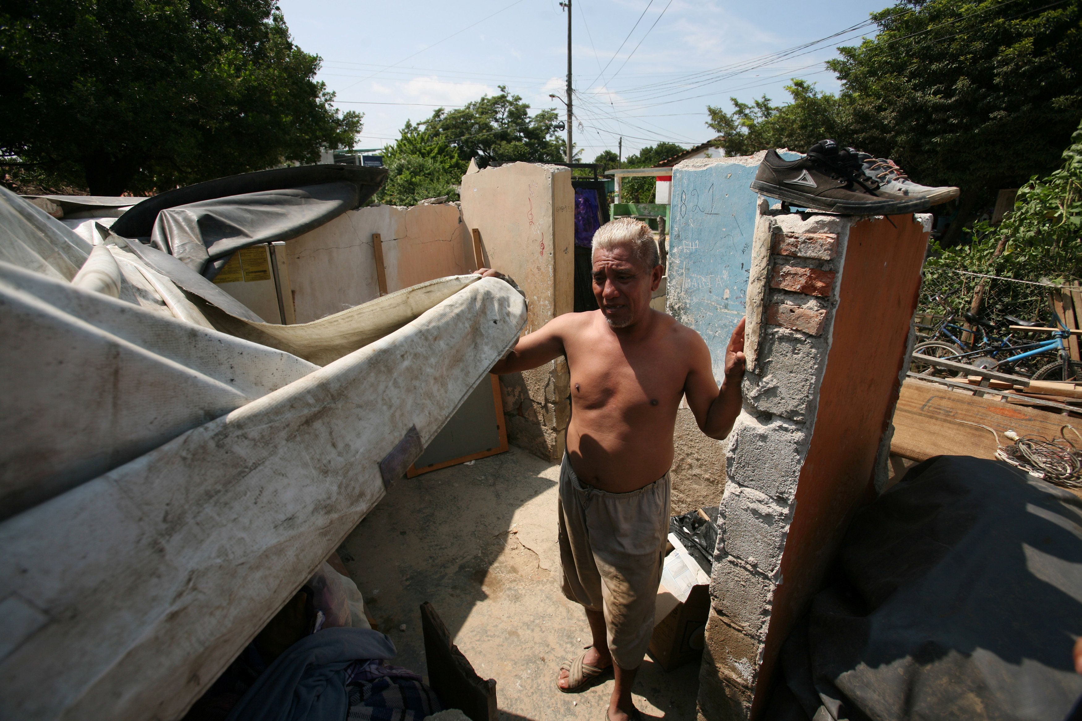 A man stands inside of what his left of his home after an earthquake struck the southern coast of Mexico in Union Hidalgo, Mexico on Sept. 9, 2017. (REUTERS/Jorge Luis Plata)