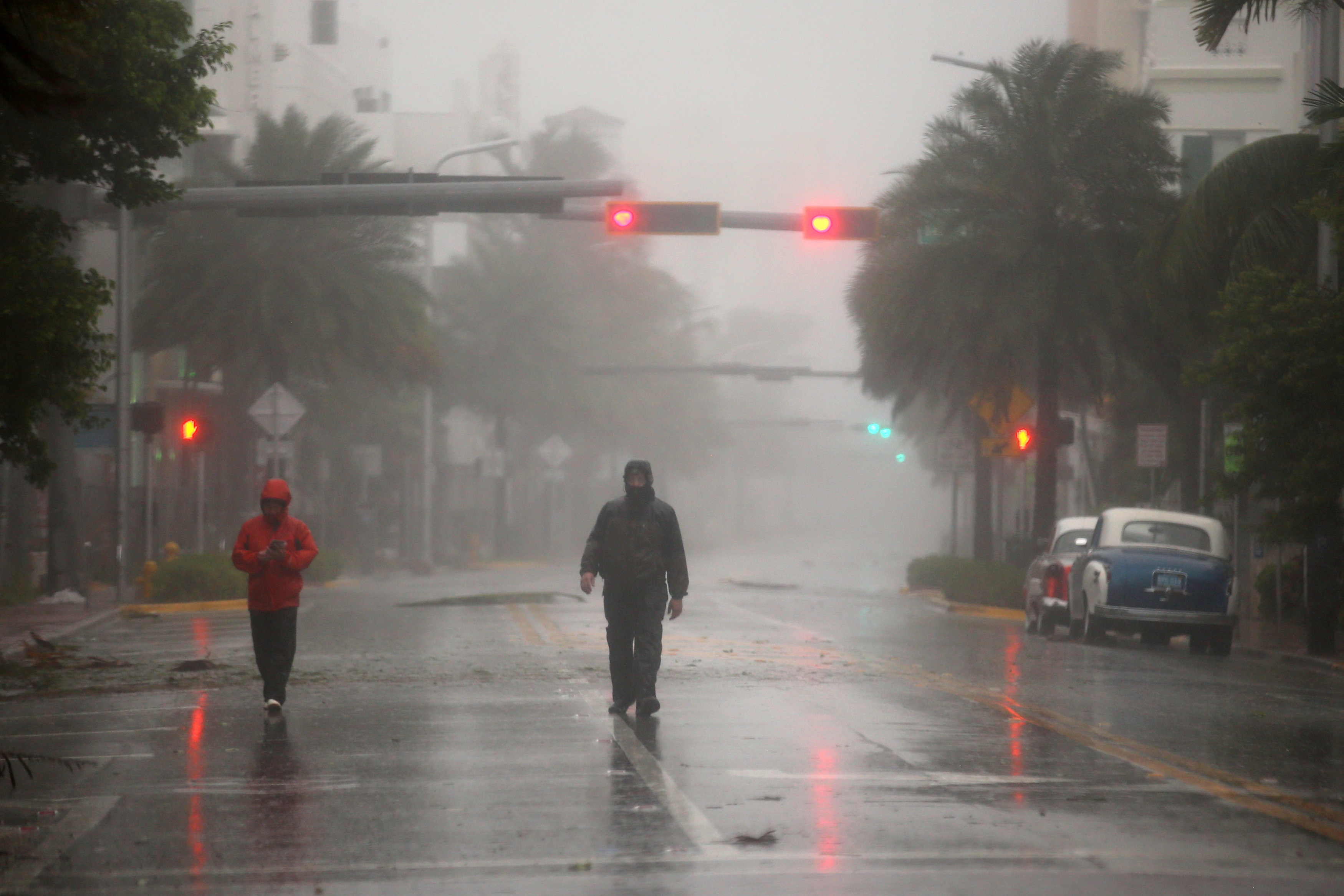 People walk along a street in South Beach as Hurricane Irma arrives at south Florida, in Miami Beach, Florida on Sept. 10, 2017. (REUTERS/Carlos Barria)
