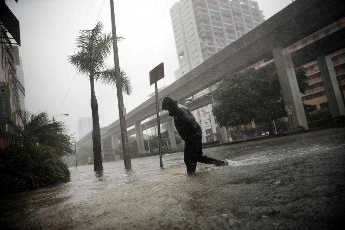 A local resident walks across a flooded street in downtown Miami as Hurricane Irma arrives at south Florida on Sept. 10, 2017. (REUTERS/Carlos Barria)