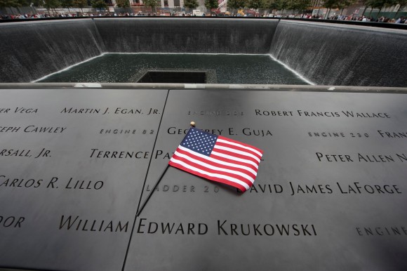 A US flag at the memorial wall on the South Tower reflecting pool of the World Trade Center September 11, 2011 in New York. AFP PHOTO/DON EMMERT / AFP / DON EMMERT (Photo credit should read DON EMMERT/AFP/Getty Images)