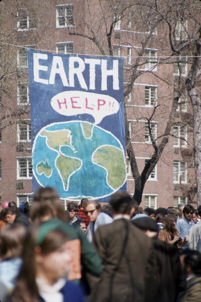 People gather near a large poster that shows a speech bubble from planet Earth that reads 'Help!!', on the occasion of the first Earth Day conservation awareness celebration, New York City, on April 22, 1970. (Hulton Archive/Getty Images)