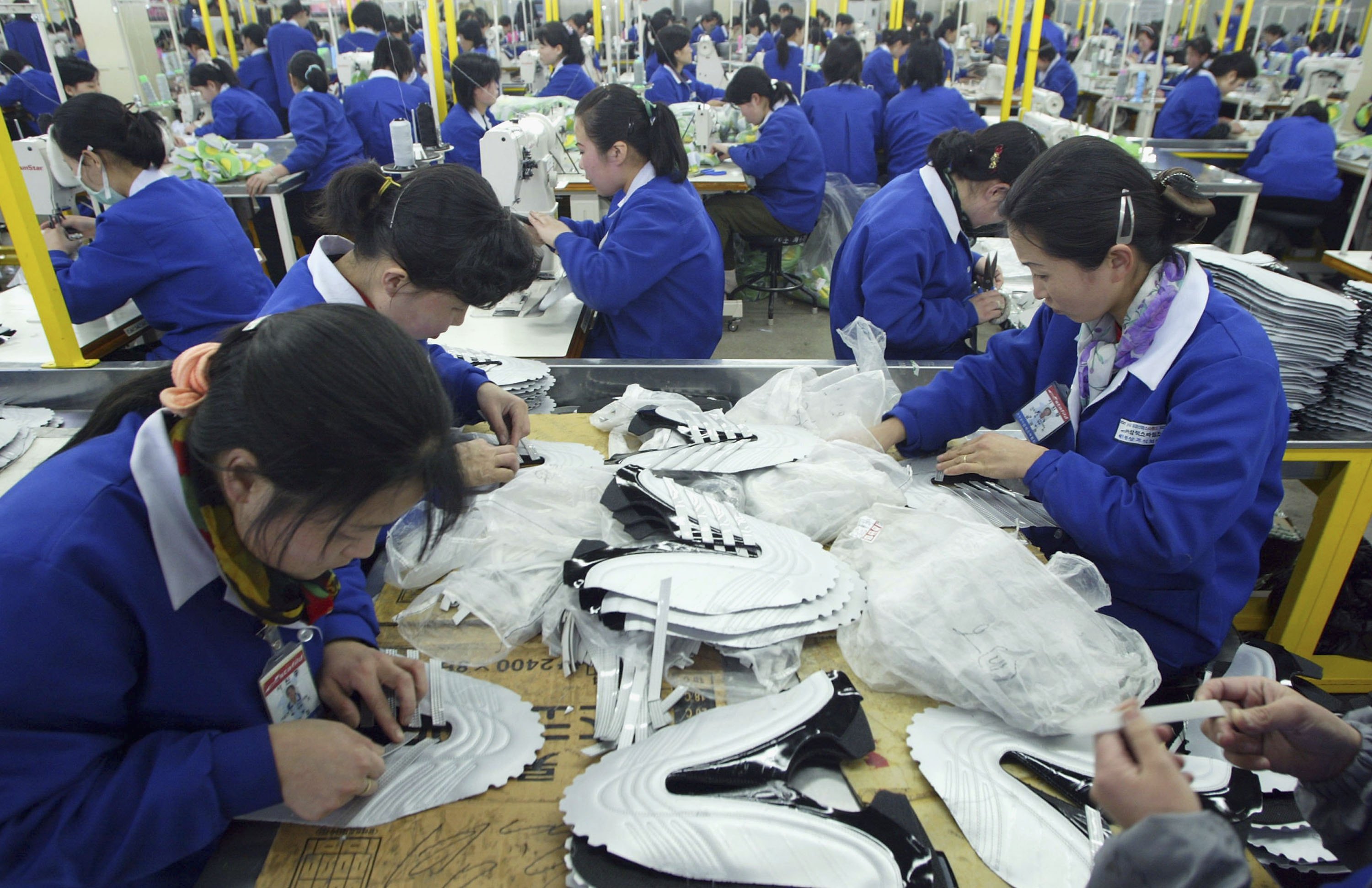 North Korean women work at the assembly line of the factory of shoemaker Samduk Inc. at the Kaesong industrial complex in Kaesong, North Korea on Feb. 27, 2006. (photo by Chung Sung-Jun/Getty Images)