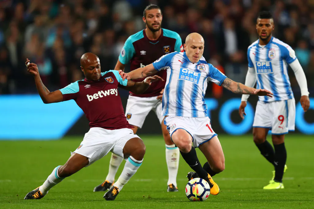 Andre Ayew of West Ham United and Aaron Mooy of Huddersfield Town battle for the ball during the Premier League match between West Ham United and Huddersfield Town at London Stadium on Sept 11, 2017 in London, England. (Clive Rose/Getty Images)
