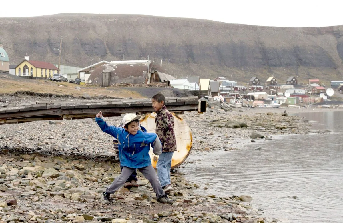 Children skip stones in Arctic Bay, Nunavut, in this file photo. Although tuberculosis is almost unheard of in the south, it is present in many northern reserves and in 17 out of 25 Nunavut communities. (The Canadian Press/Adrian Wyld)