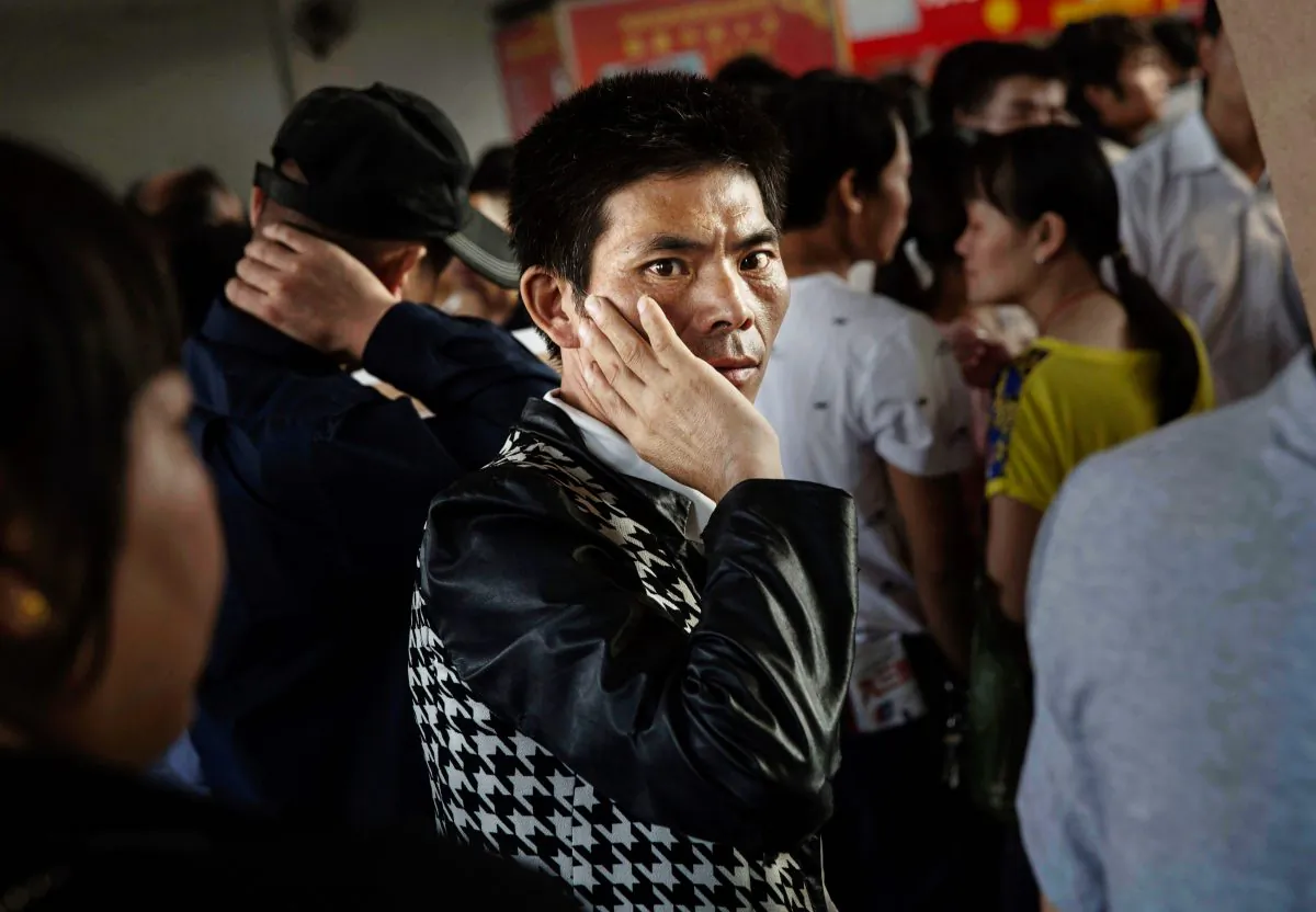 A Chinese man stands inside a job center on September 18, 2015 in Yiwu, Zhejiang Province, China in 2015. China’s slower economy has left many desperate for work, making them vulnerable to pyramid schemes that are evolving into criminal syndicates. (Kevin Frayer/Getty Images)