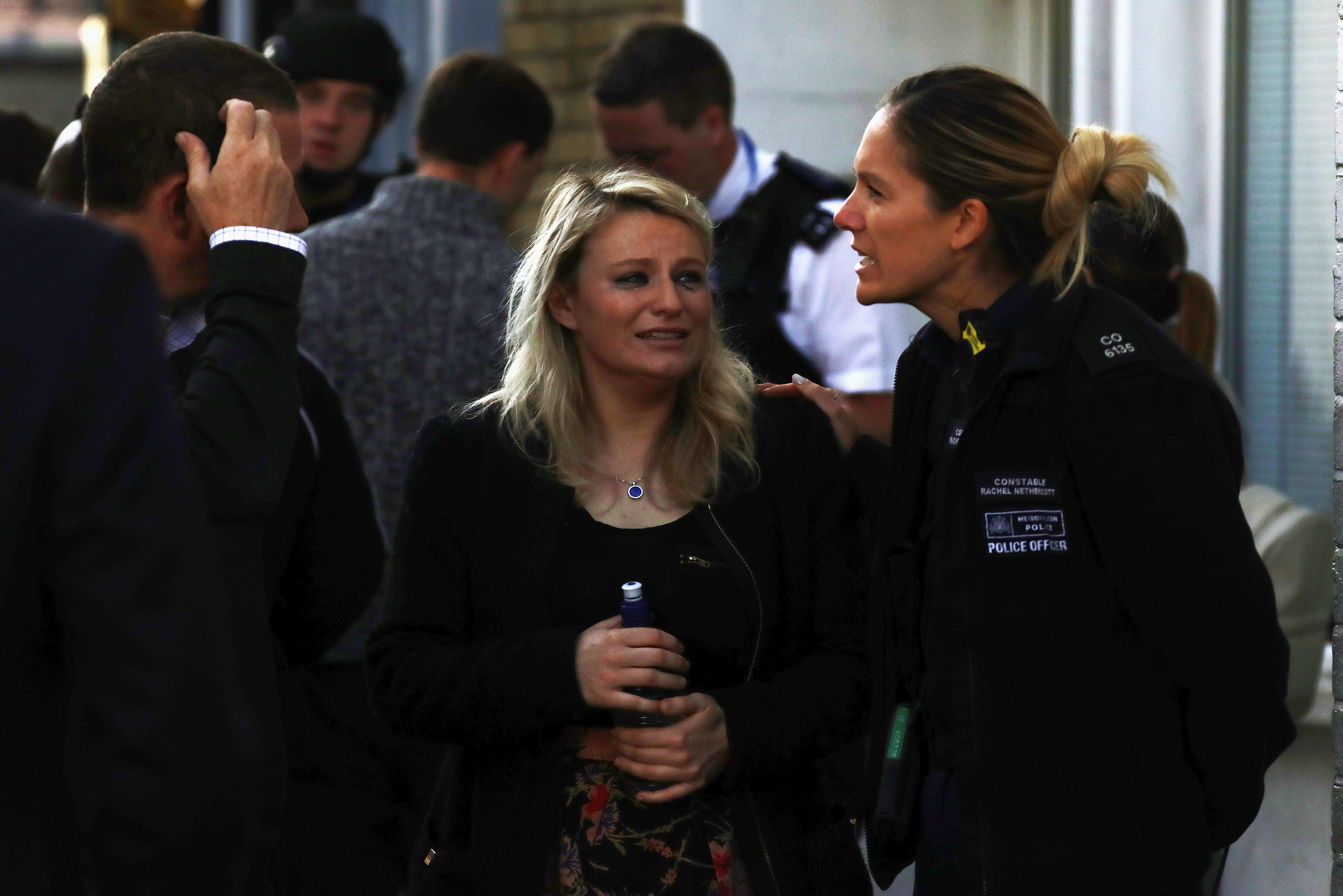 A woman reacts outside Parsons Green tube station in London, Britain on Sept. 15, 2017. (REUTERS/Kevin Coombs)
