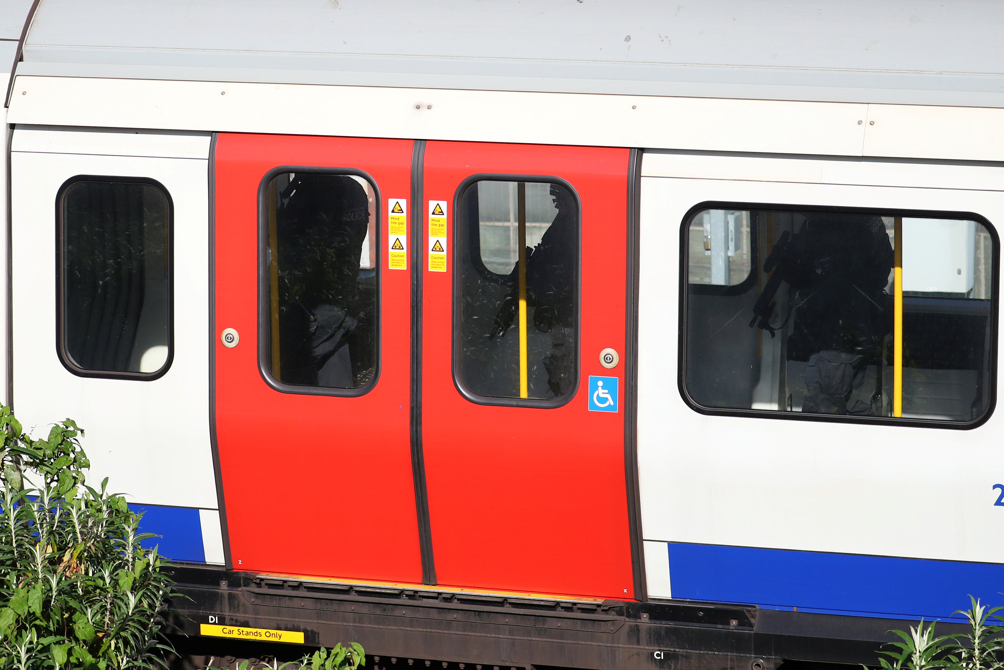 Armed police officers walk through a carriage of a London underground tube train at Parsons Green station in London, Britain on Sept. 15, 2017. (REUTERS/Hannah McKay)