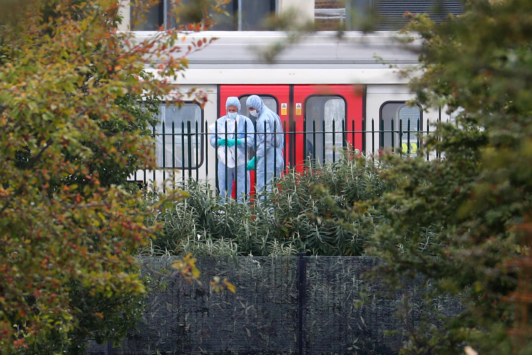 Forensic investigators search next to a London underground tube at Parsons Green station in London, Britain on Sept. 15, 2017. (REUTERS/Hannah McKay)