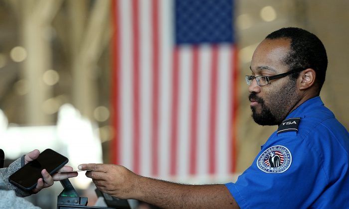 A TSA officer checks travel documents at Reagan National Airport in Arlington, Va., Nov. 25, 2015. (Win McNamee/Getty Images)