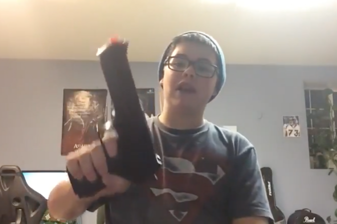 Caleb Sharpe shows an airsoft handgun he pledged to let himself be shot with 60 times if he gained 60 subscribers in this YouTube video. (Screenshot/YouTube)