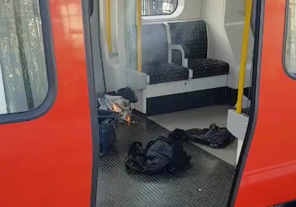 Personal belonglongs and a bucket with an item on fire inside it, are seen on the floor of an underground train carriage at Parsons Green station in West London, Britain September 15, 2017, in this image taken from social media. (Sylvain Pennec/via Reuters)