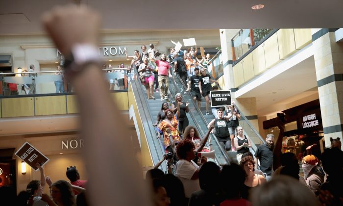 Demonstrators march through the West County Mall protesting the acquittal of former St. Louis police officer Jason Stockley on September 16, 2017 in St. Louis, Missouri. The St. Louis area is bracing for a second day of protests following yesterday's acquittal of Stockley, who was charged with first-degree murder last year following the 2011 shooting of Anthony Lamar Smith.   U2 cancelled its show scheduled Saturday night due to the protests. (Scott Olson/Getty Images)