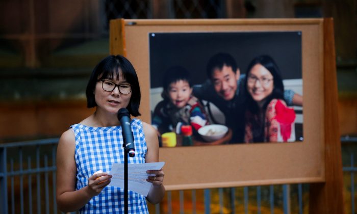 Hua Qu speaks to people as they attend a vigil for Xiyue Wang at Princeton University in Princeton, New Jersey, on Sept. 15, 2017. (REUTERS/Eduardo Munoz)