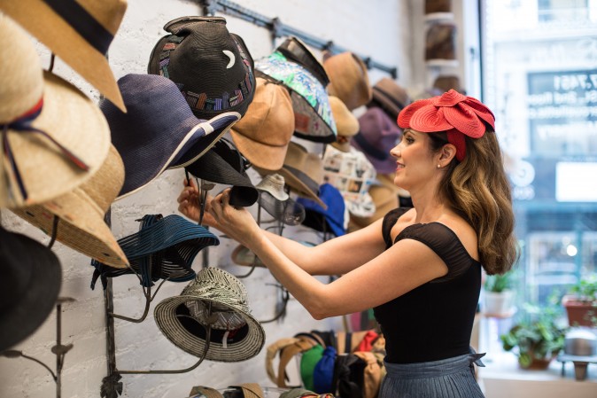 Jennifer Ouellette puts hats for display at her studio in New York on Sept. 15, 2017. (Benjamin Chasteen/The Epoch Times)