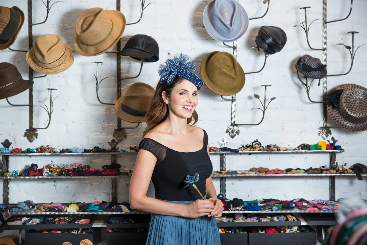 Jennifer Ouellette with a collection of her handmade hats at her Jennifer Ouellette studio in New York on Sept. 15, 2017. (Benjamin Chasteen/The Epoch Times)