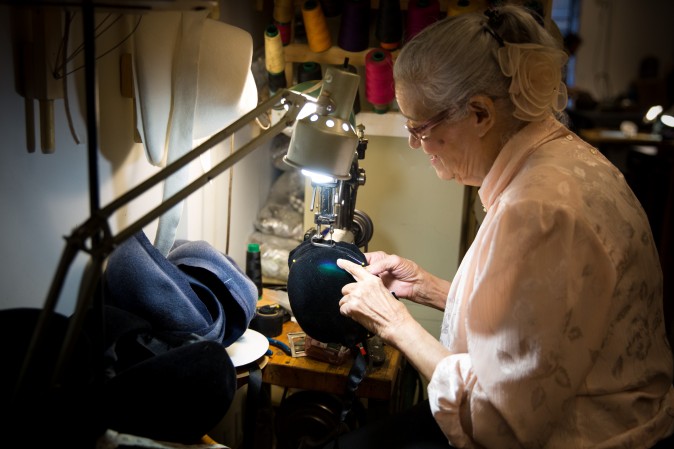 Georgina Sanchez, who has been working in the Garment District for over 40 years, use a sewing machine that is over 100 years old at the Jennifer Ouellette studio. (Benjamin Chasteen/The Epoch Times)