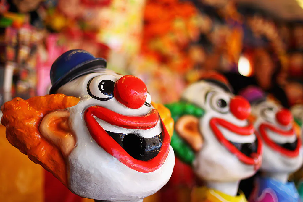 A crazy laughing clown is seen in the carnival area during a show. (Mark Kolbe/Getty Images)