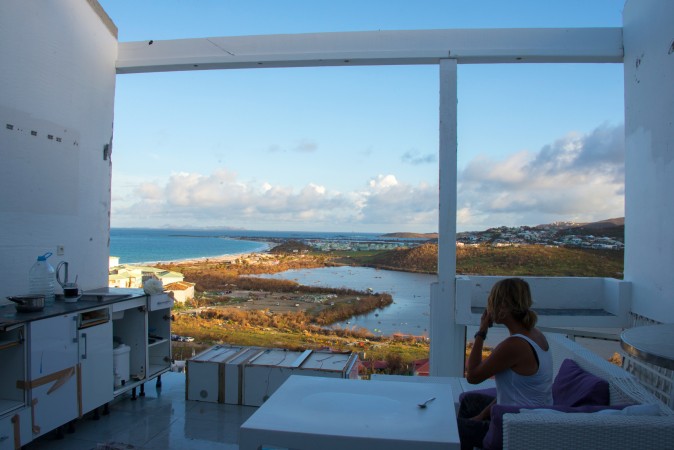 A woman looks out from her living room of her home which is now missing a roof and windows in the aftermath of hurricane Irma on the French Caribbean island of Saint Martin on Sept. 17. (HELENE VALENZUELA/AFP/Getty Images) 