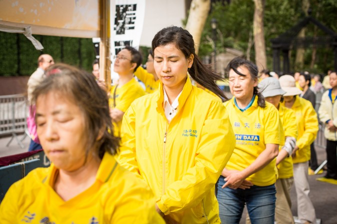 Falun Gong exercise at the Dag Hammarskjold Plaza near the United Nations headquarters in New York on Sept. 19, 2017, to raise awareness about the persecution inside China that is now in its 18th year. (Benjamin Chasteen/The Epoch Times)