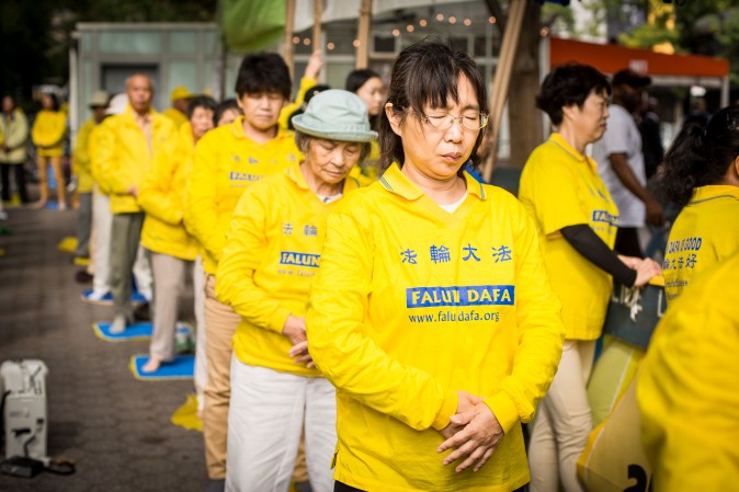 Falun Gong exercise at the Dag Hammarskjold Plaza near the United Nations headquarters in New York on Sept. 19, 2017, to raise awareness about the persecution inside China that is now in its 18th year. (Benjamin Chasteen/The Epoch Times)