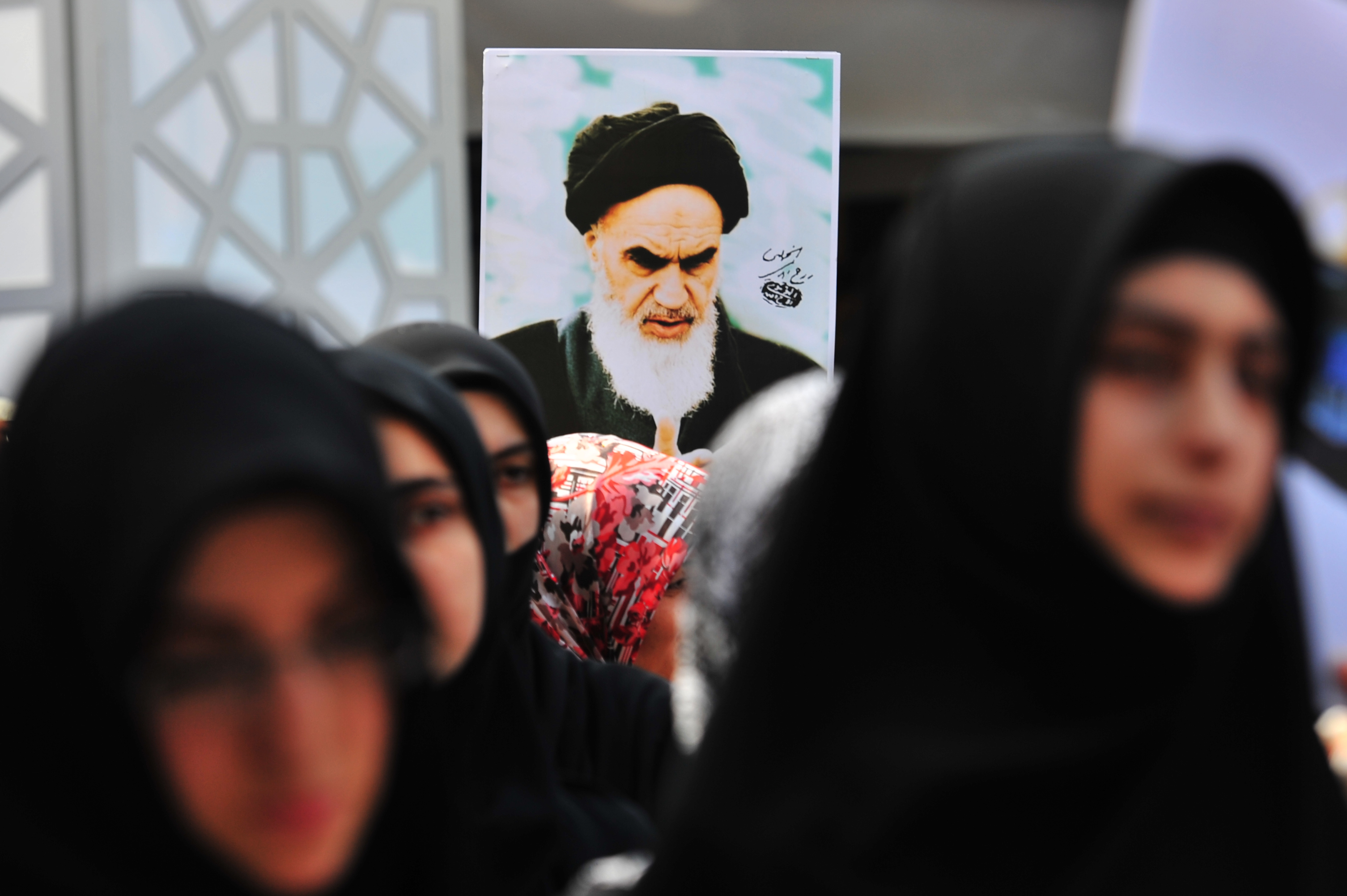 A Turkish Muslim woman holds a picture of Iran's late leader Ayatollah Khomeini during a protest in front of Beyazit Mosque after a Friday pray in Istanbul on Aug. 26, 2011. (MUSTAFA OZER/AFP/Getty Images)