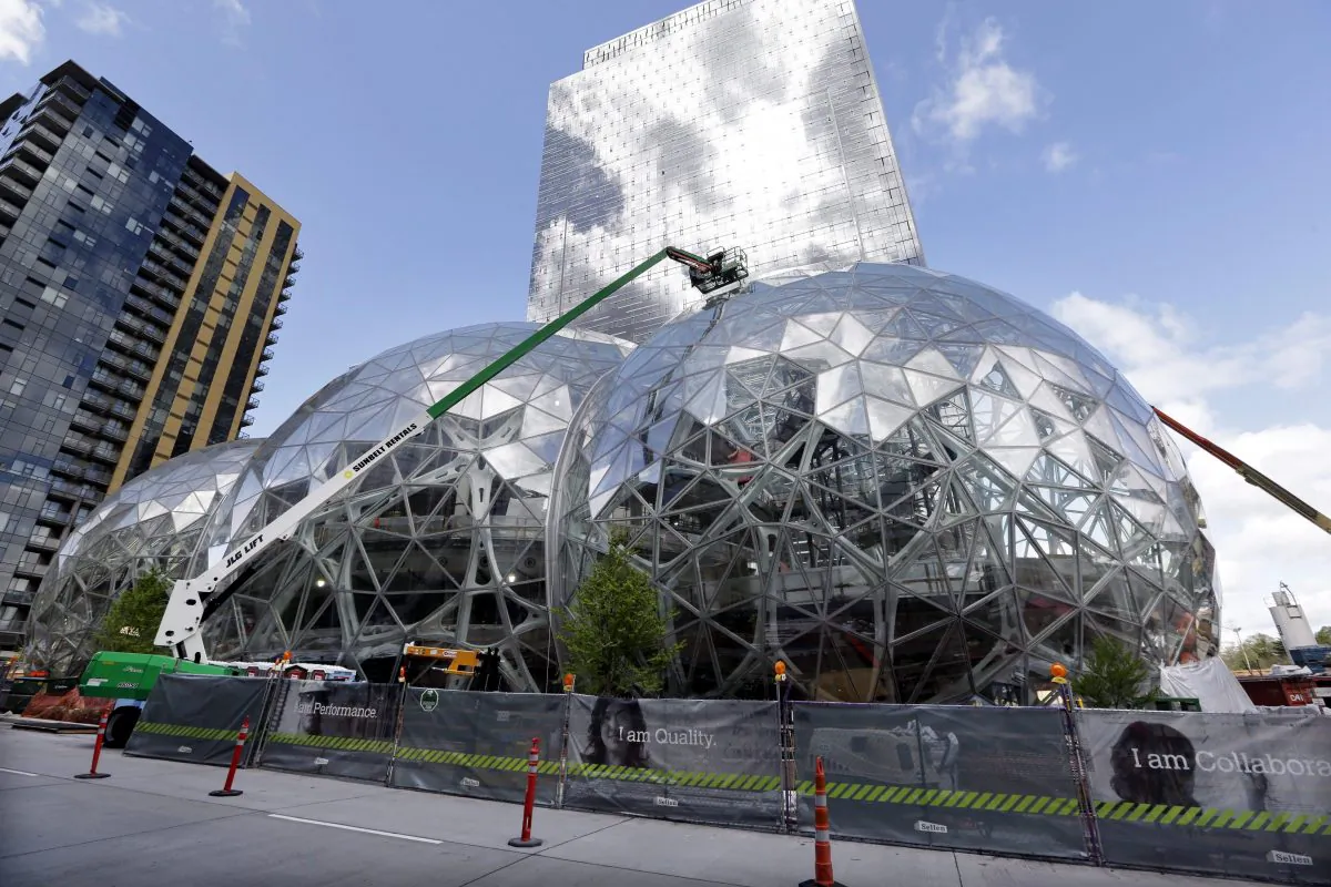 Construction continues on three large glass-covered domes as part of an expansion of the Amazon.com campus in downtown Seattle, April 27, 2017. Amazon plans to spend more than $5 billion to build another headquarters in North America to house as many as 50,000 employees. (AP Photo/Elaine Thompson)