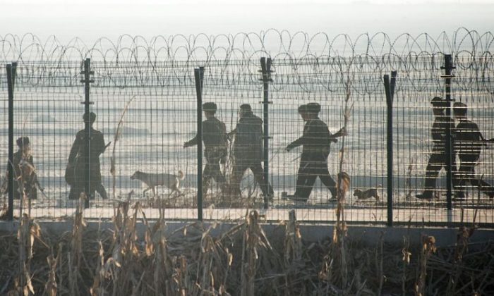North Korean soldiers patrol next to the border fence near the town of Sinuiju across from the Chinese border town of Dandong on Feb. 10, 2016. (JOHANNES EISELE/AFP/Getty Images)