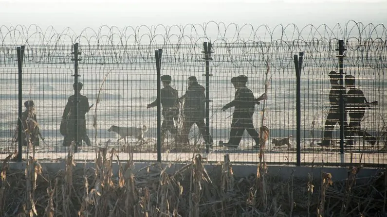 North Korean soldiers patrol next to the border fence near the town of Sinuiju across from the Chinese border town of Dandong on Feb. 10, 2016. (JOHANNES EISELE/AFP/Getty Images)