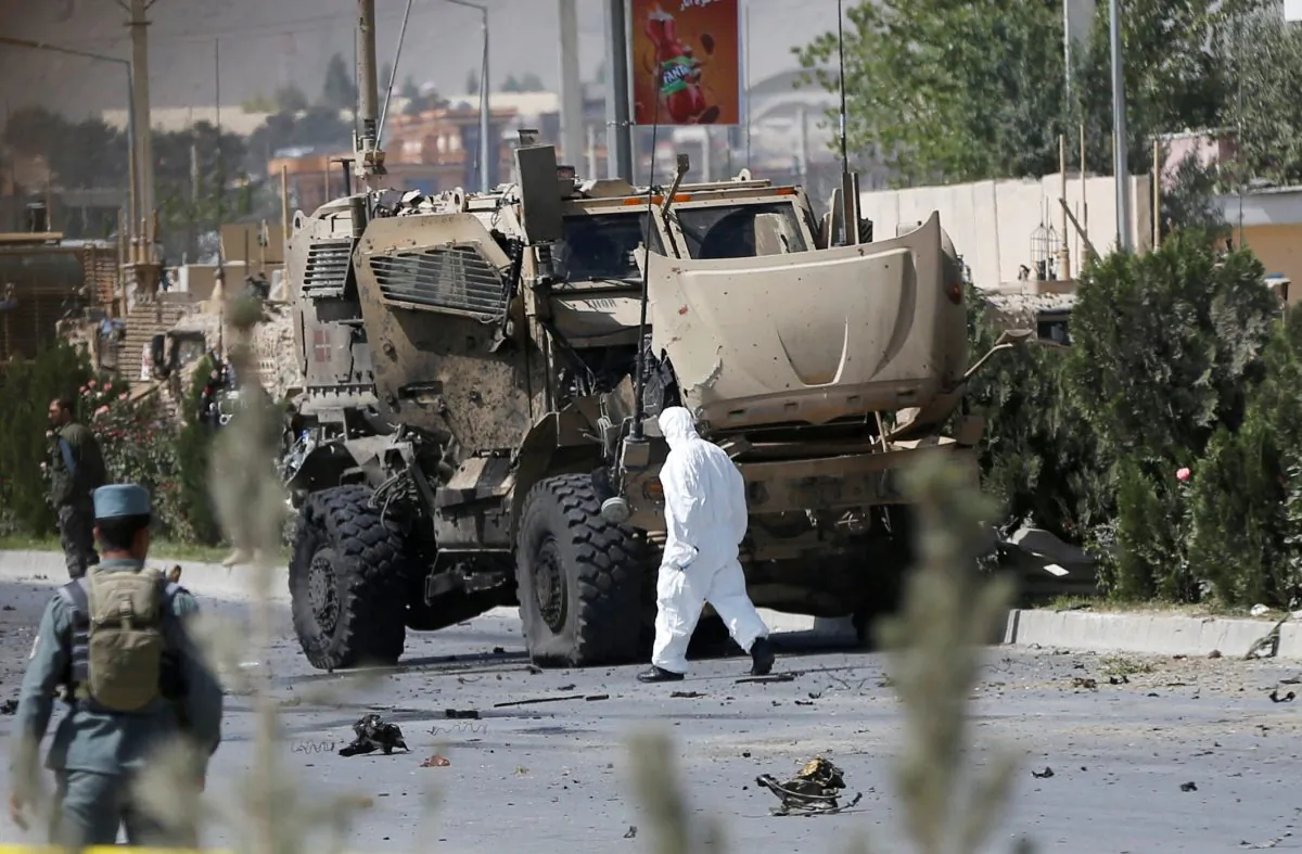 An Afghan official investigates a damaged Danish convoy at the site of a car bomb attack in Kabul, Afghanistan September 24, 2017. 
(Reuters/Omar Sobhani)