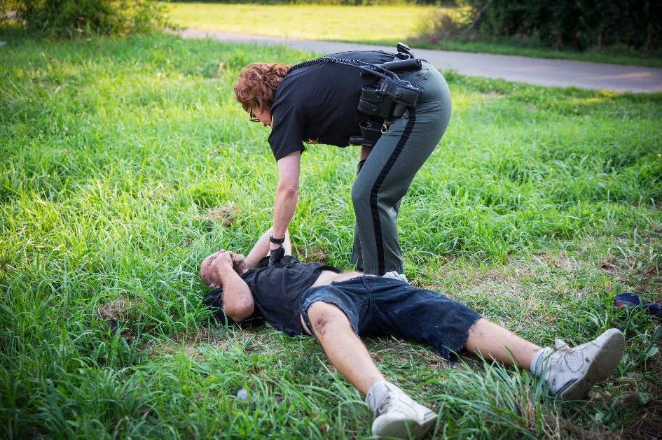 Montgomery County Deputy Sheriff Jennifer Smiley helps a man who is overdosing in the Drexel neighborhood of Dayton, Ohio, on Aug. 3, 2017. (Benjamin Chasteen/The Epoch Times)