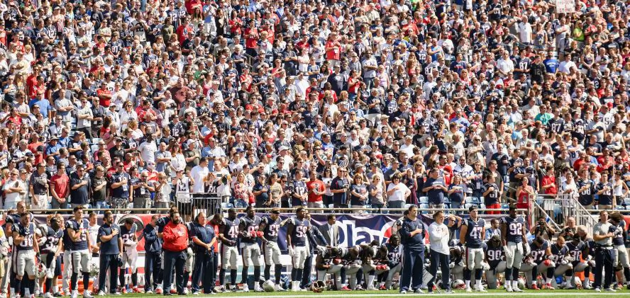 Members of the New England Patriots kneel on the sidelines as the national anthem is played before a game against the Houston Texans at Gillette Stadium in Foxboro, Mass., on Sept. 24, 2017. (Billie Weiss/Getty Images)