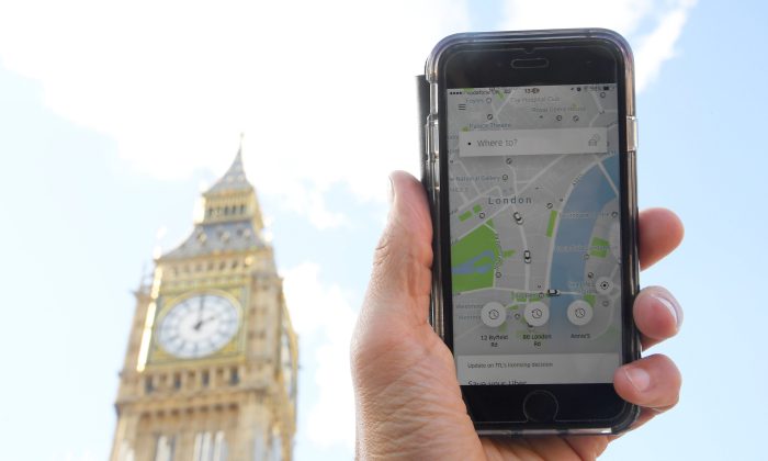 A photo illustration shows the Uber app on a mobile telephone, as it is held up for a posed photograph in central London, Britain on Sept. 22, 2017. (REUTERS/Toby Melville)