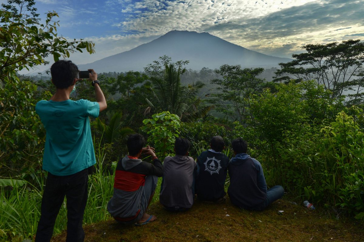 People look at Mount Agung on the Indonesian resort island of Bali on Sept. 24, 2017. Hundreds of small tremors stoked fears it could erupt for the first time in more than 50 years. (Sonny Tumbelaka/AFP/Getty Images)