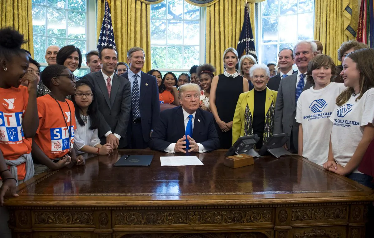 President Donald Trump speaks alongside students, members of congress, and his Administration before signing a memorandum to expand access to STEM education in the Oval Office at the White House on Sep. 25, 2017. (Kevin Dietsch-Pool/Getty Images)