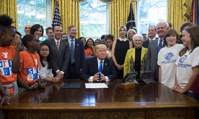 President Donald Trump speaks alongside students, members of congress, and his Administration before signing a memorandum to expand access to STEM education in the Oval Office at the White House on Sep. 25, 2017. (Kevin Dietsch-Pool/Getty Images)