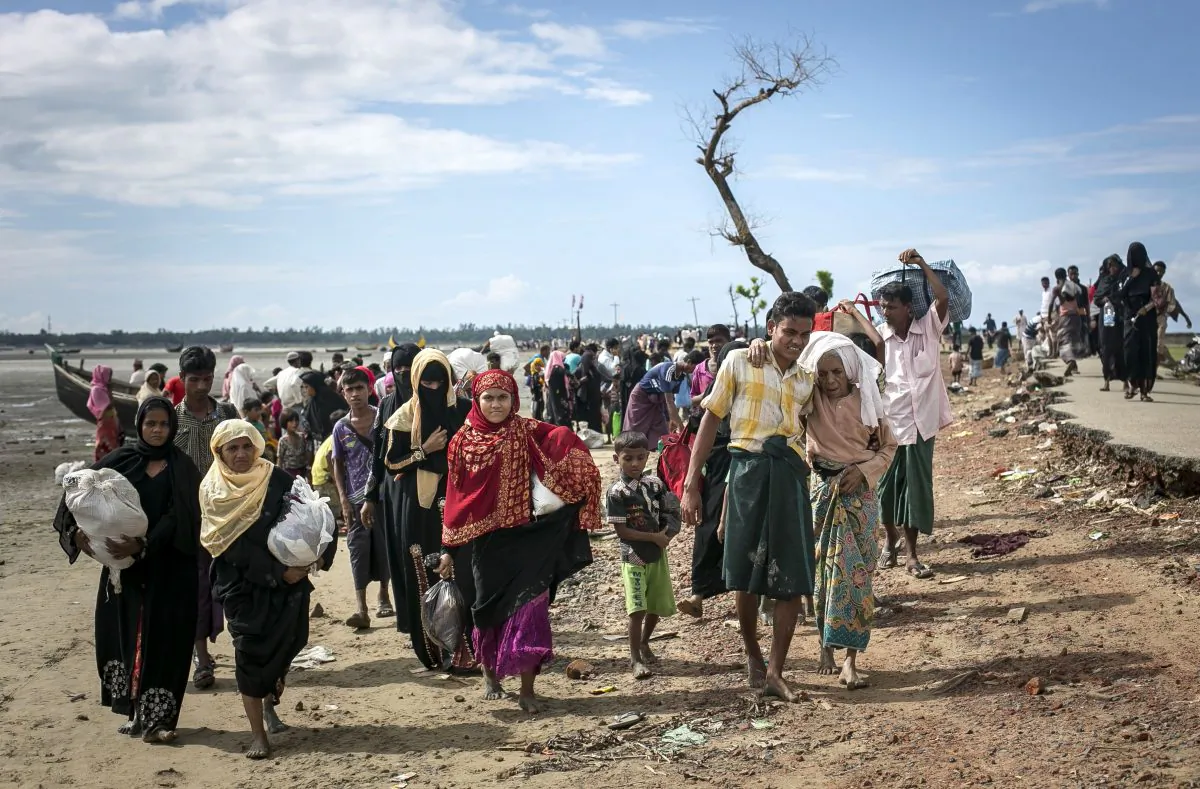 Rohingya refugees make their way along a beach after arriving by boat at Shah Porir Dip, Bangladesh, on Sept. 14, 2017. (Allison Joyce/Getty Images)