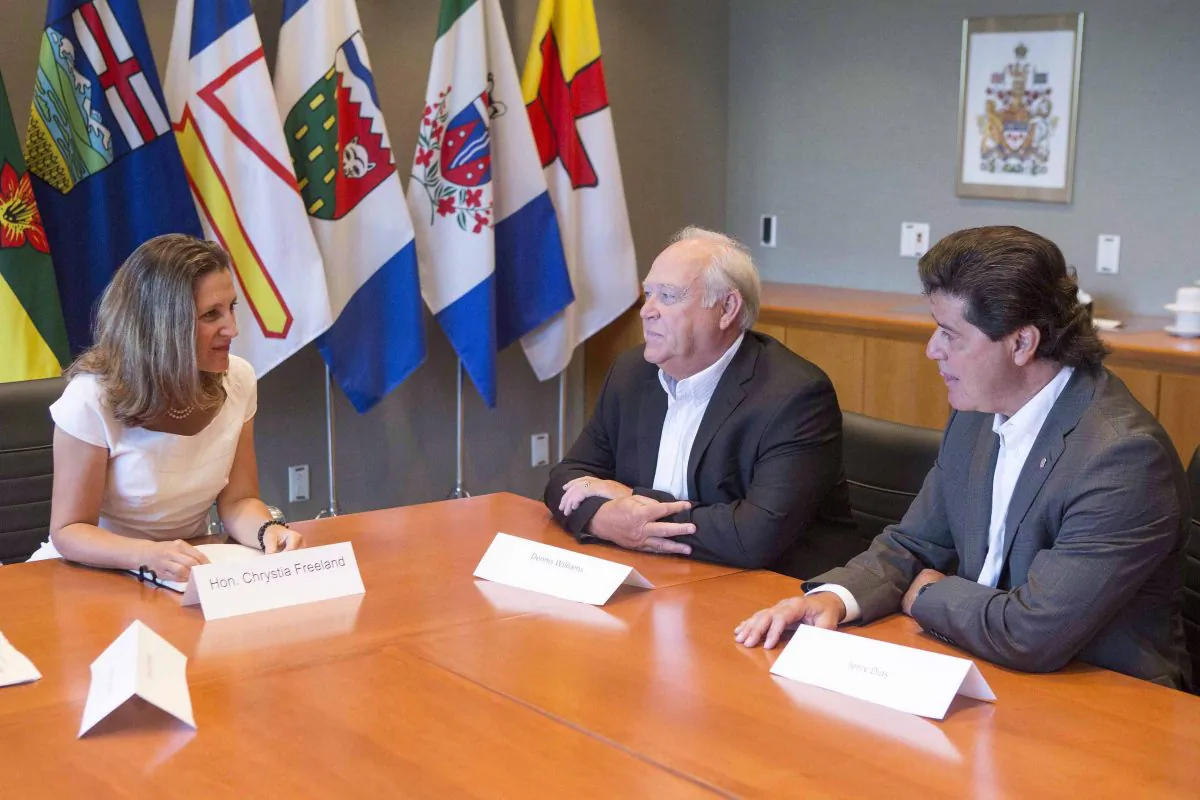 Foreign Affairs Minister Chrystia Freeland (L) sits with Unifor President Jerry Dias (R) and United Auto Workers President Dennis Williams in Toronto on Aug. 25, 2017, ahead of an upcoming round of NAFTA renegotiations. (The Canadian Press/Chris Young)